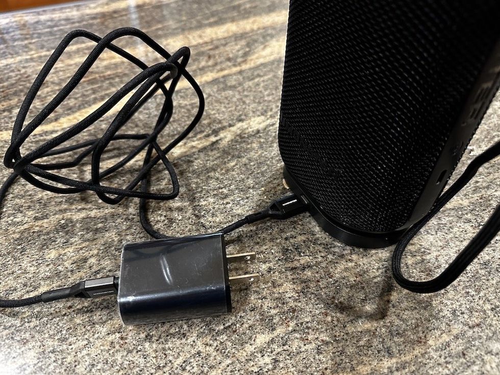 a photo of Monster speaker sitting on top of the Qi Wireless charging base.