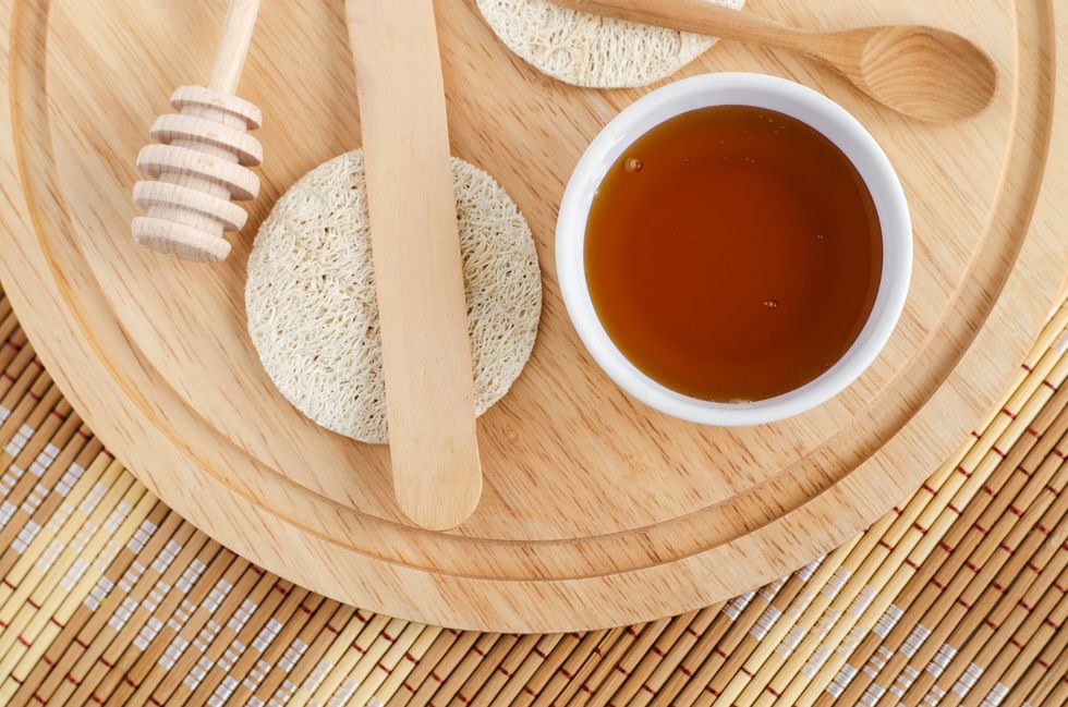 Ingredients-for-sugar-waxing-against-wooden-instruments--background