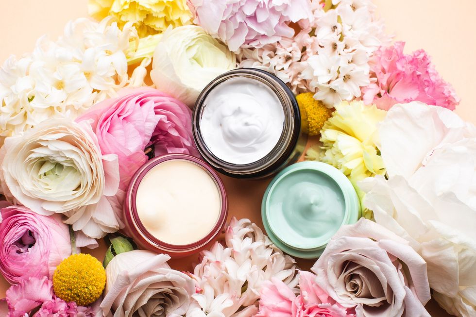 Roses-and-assorted-flowers-surrounding-open-containers-of-hydrating-conditioning-masks