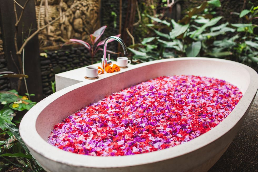 A-decadent-bathtub-outside-fillled-with-flowers