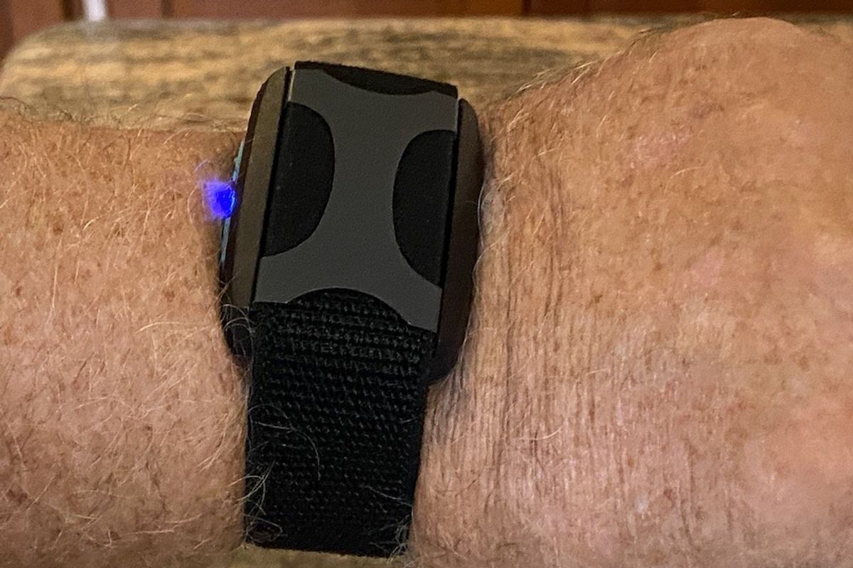 a photo of Apollo Wearable on a wrist pairing with a smartphone.