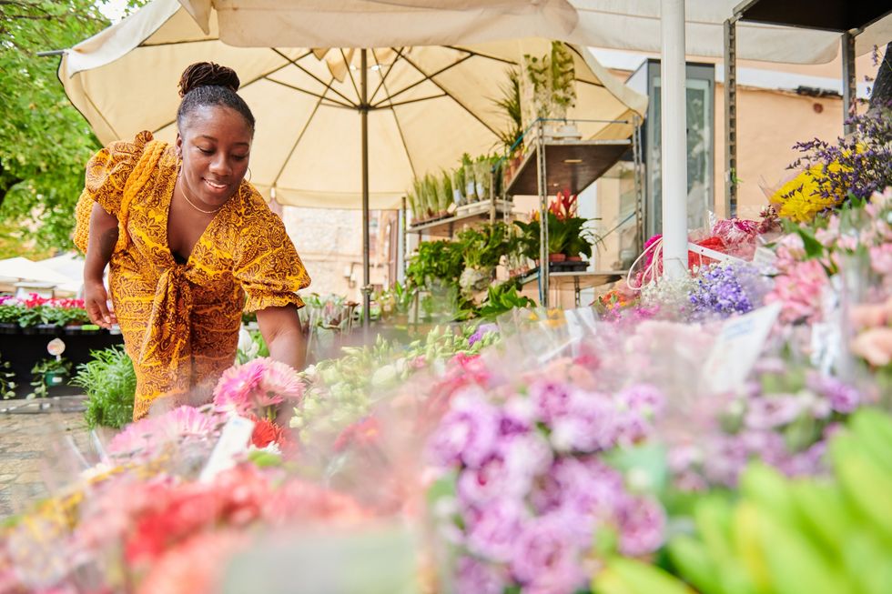 Young-woman-gathering-flower-bouquets-at-local-flower-market
