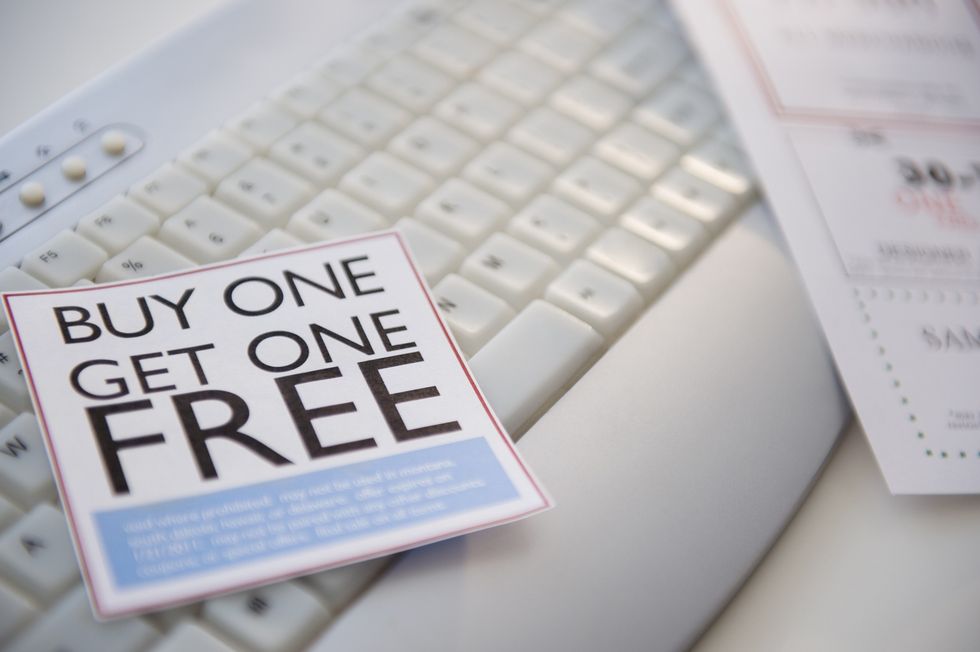 Close-up-of-buy-one-get-one-free-coupon-on-keyboard