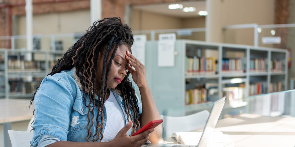 Stressed-Black-woman-checking-emails-on-laptop-and-phone