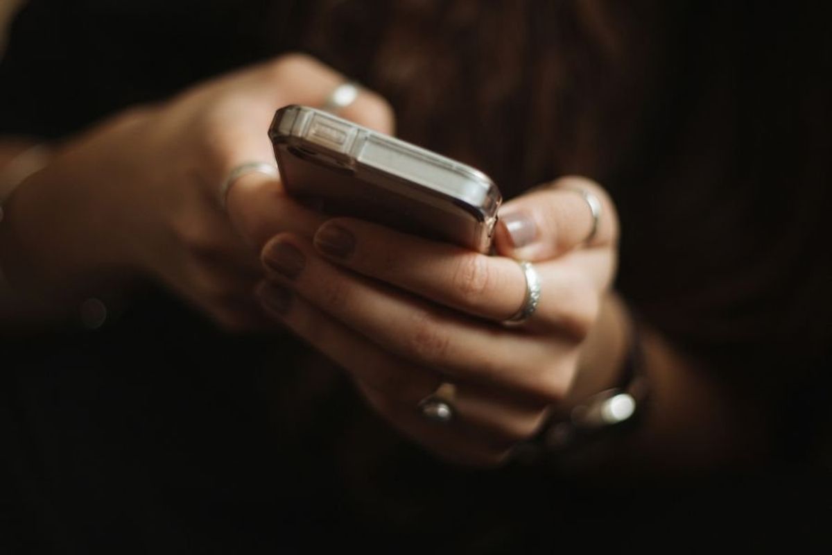 woman's hands holding a phone