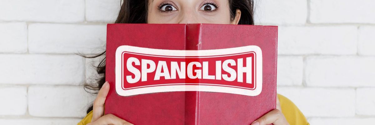 A Latina woman partially covers her face with a book that has the word "Spanglish" on the cover