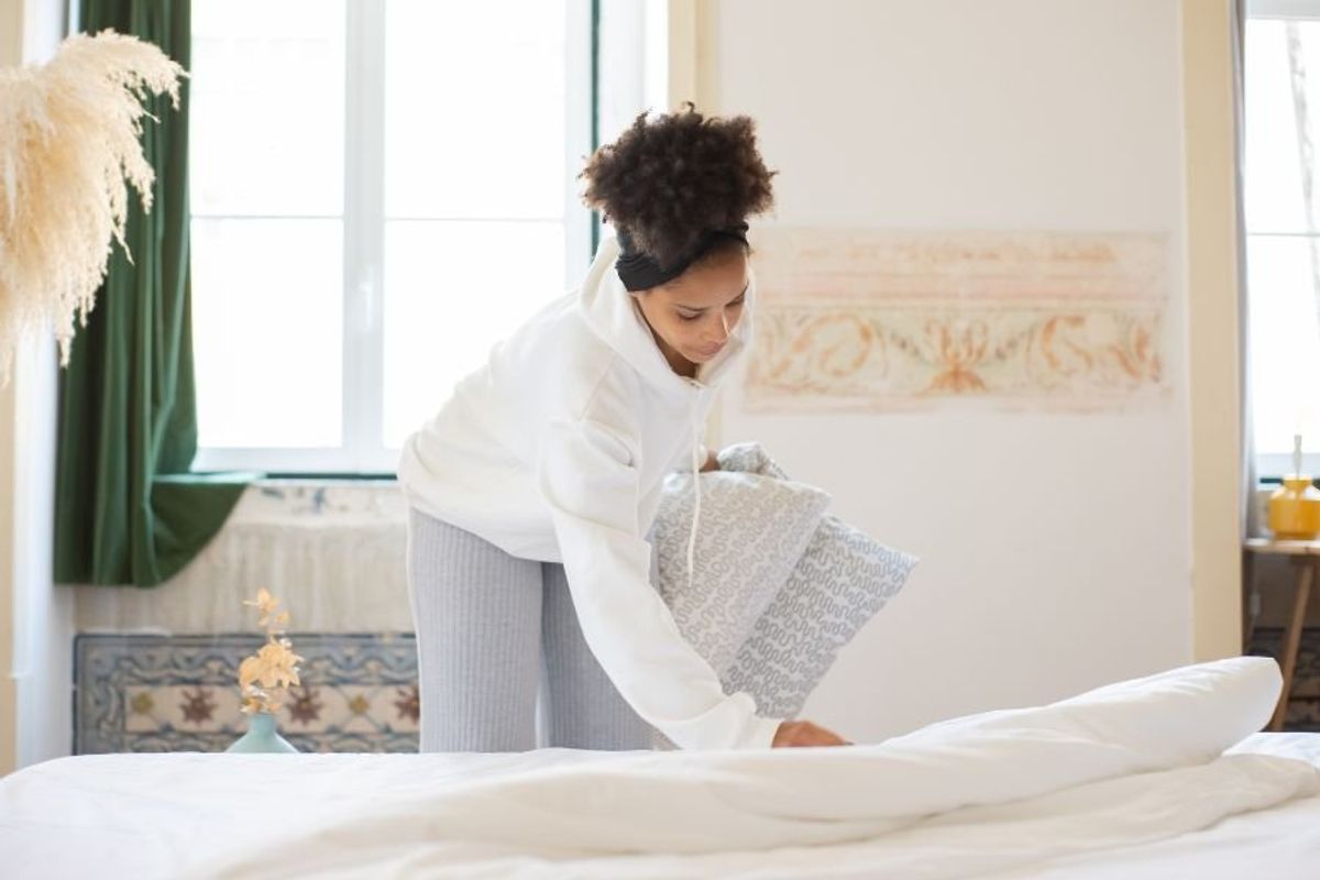 woman making a bed