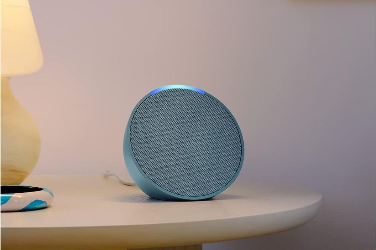 a photo of Amazon echo pop speaker on a nightstand