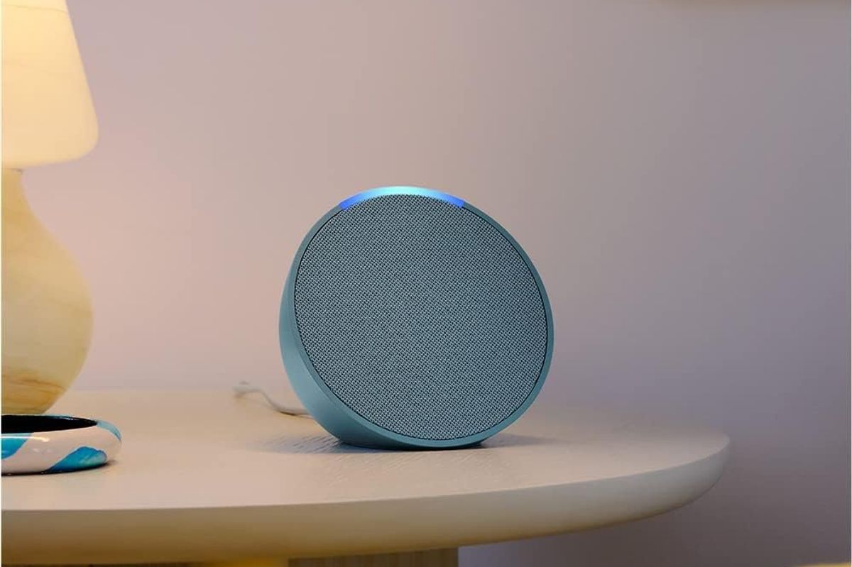 a photo of Amazon echo pop speaker on a nightstand