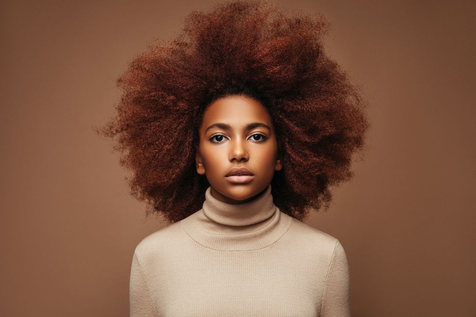 Portrait-of-young-Black-woman-with-dyed-natural-hair-worn-in-big-afro