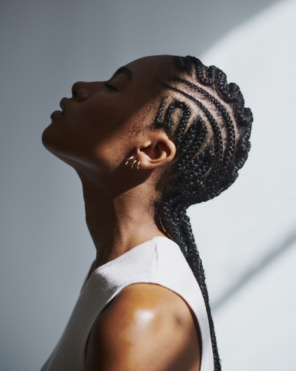 Profile-shot-of-Black-woman-wearing-cornrows-braids-style-leaning-her-head-back