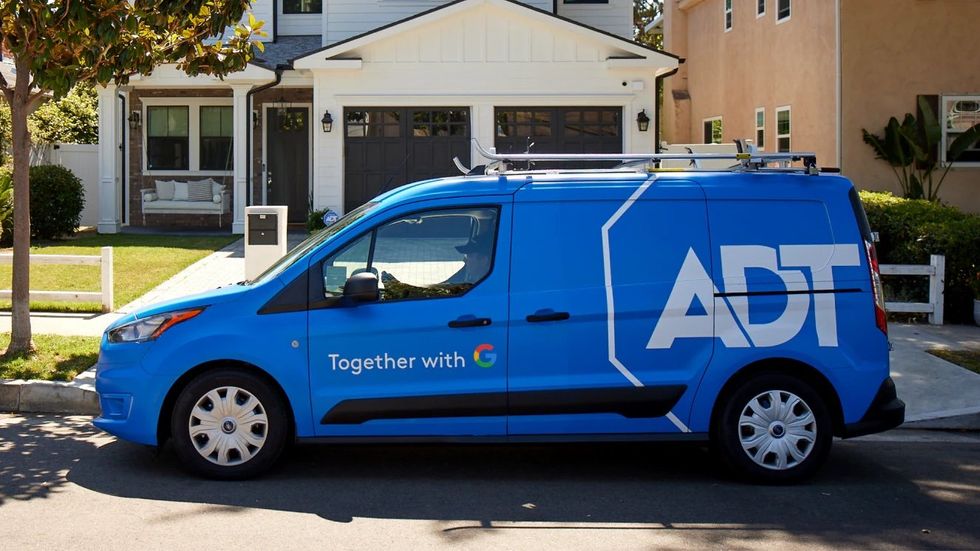 a photo of ADT professional installer truck outside a home.