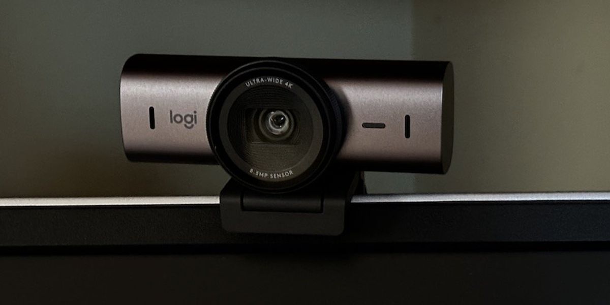 a photo of Logitech MX Brio Ultra HD 4K Webcam on a monitor with shutter open