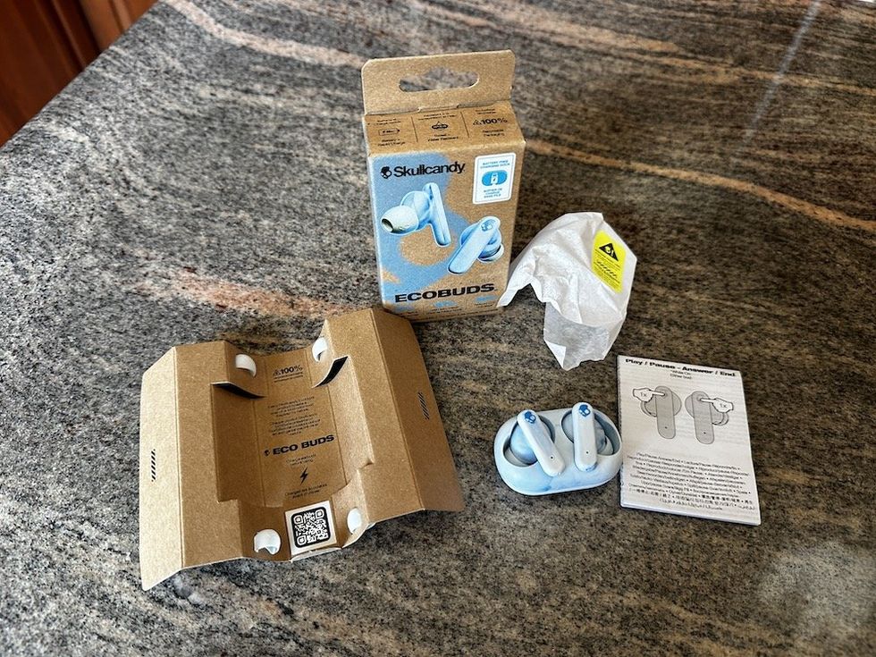 a photo of Skullcandy True Wireless Ecobuds unboxed on a countertop.