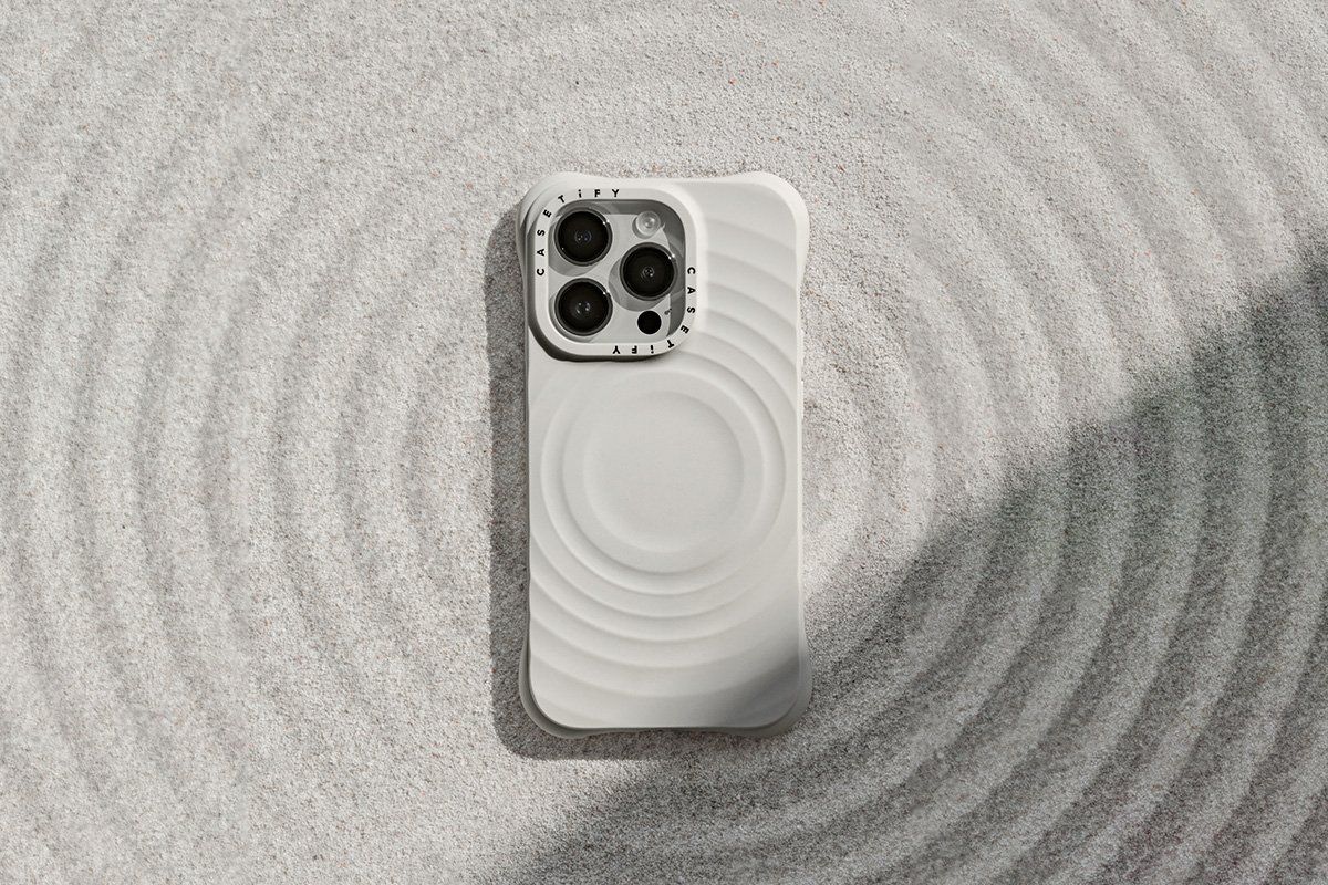 a photo of Ripple Case from CASETiFY for iPhone 13 Pro Series in the sand showing ripples.