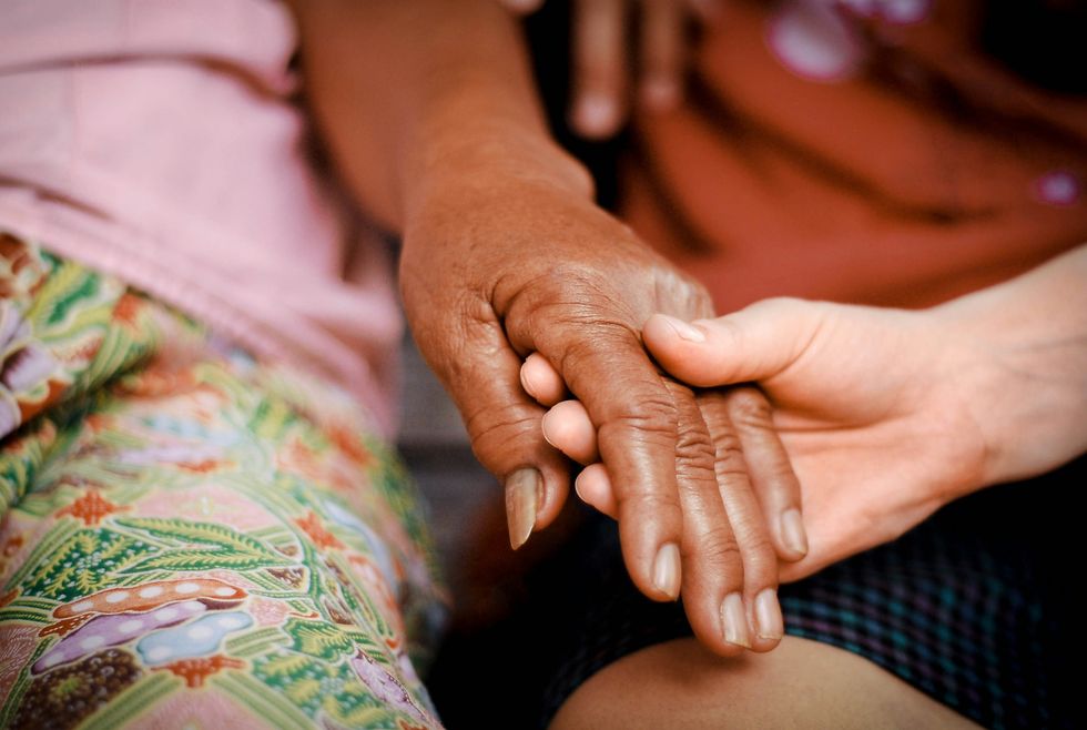 someone holding an older person's hand