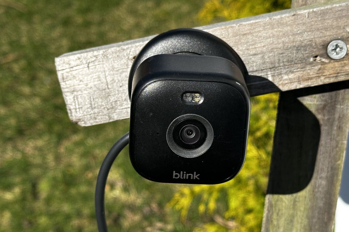 a photo of Blink Mini 2 Indoor/Outdoor Plug-in Smart Security Camera installed outside