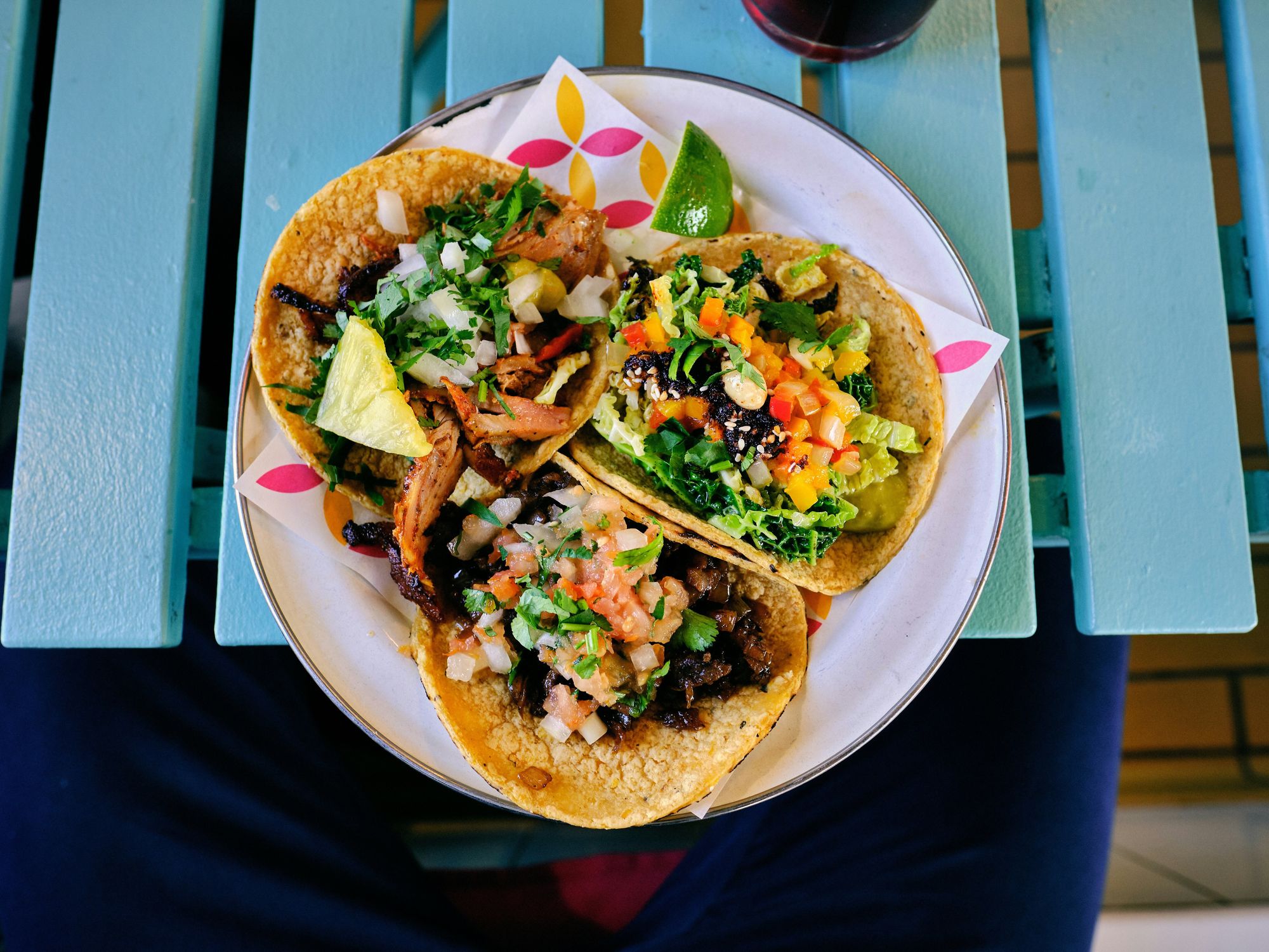 A plate full of tacos with fresh and colorful ingredients