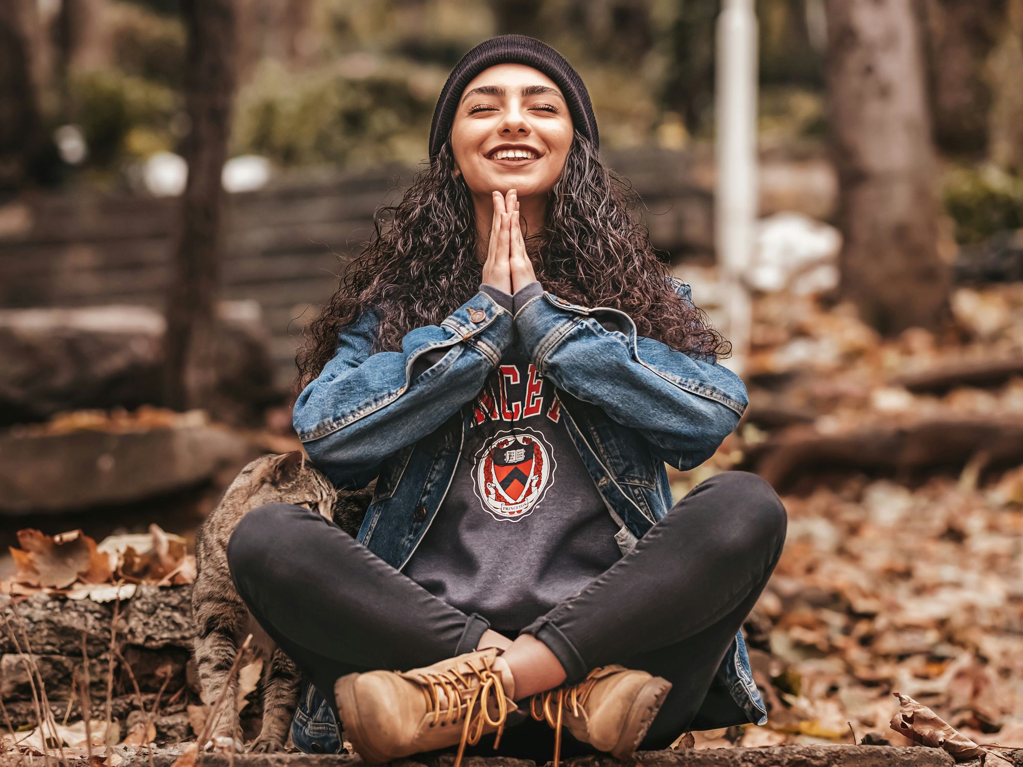 woman meditating outdoors and smiling
