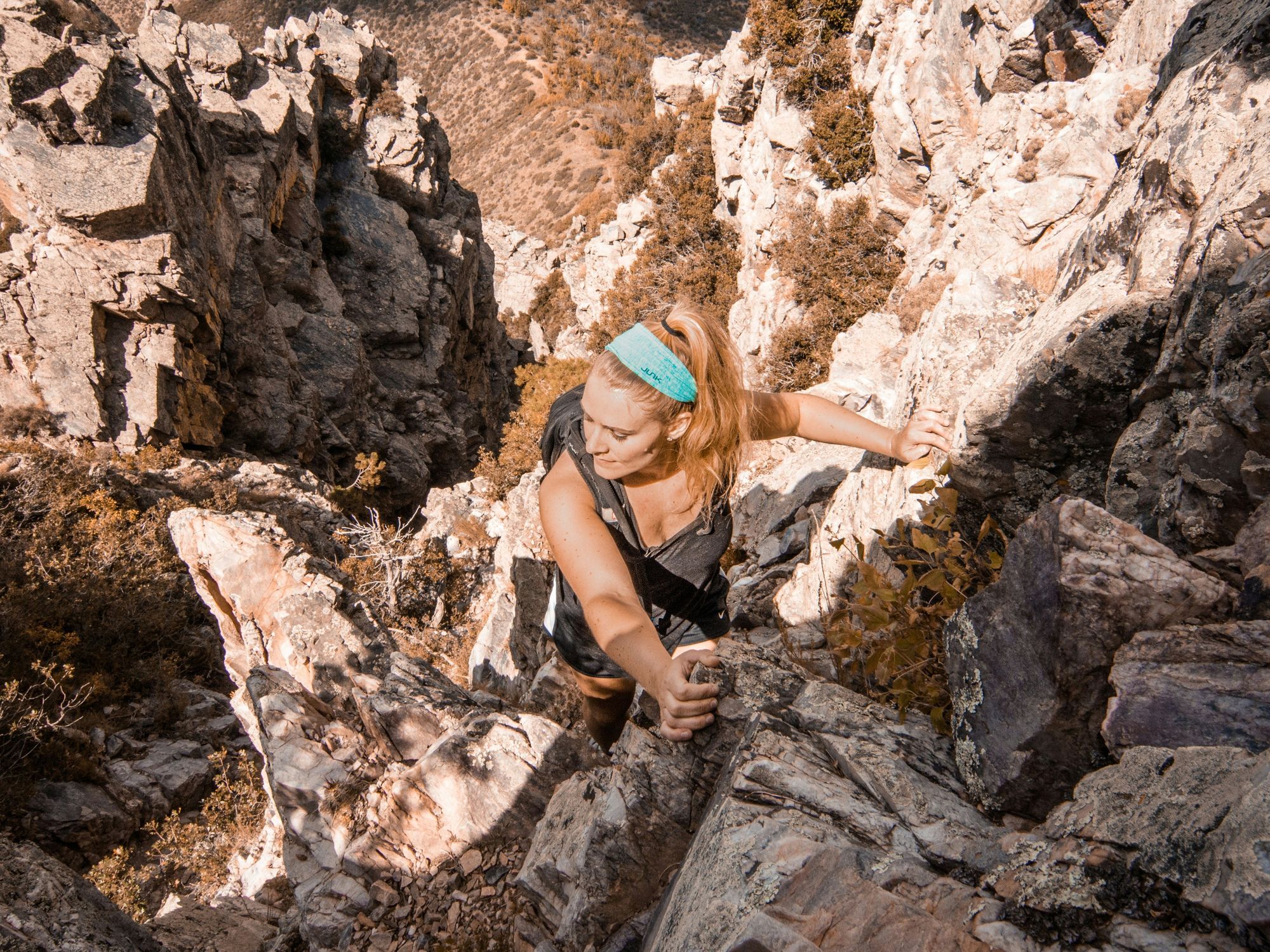 photo of woman climbing mountain