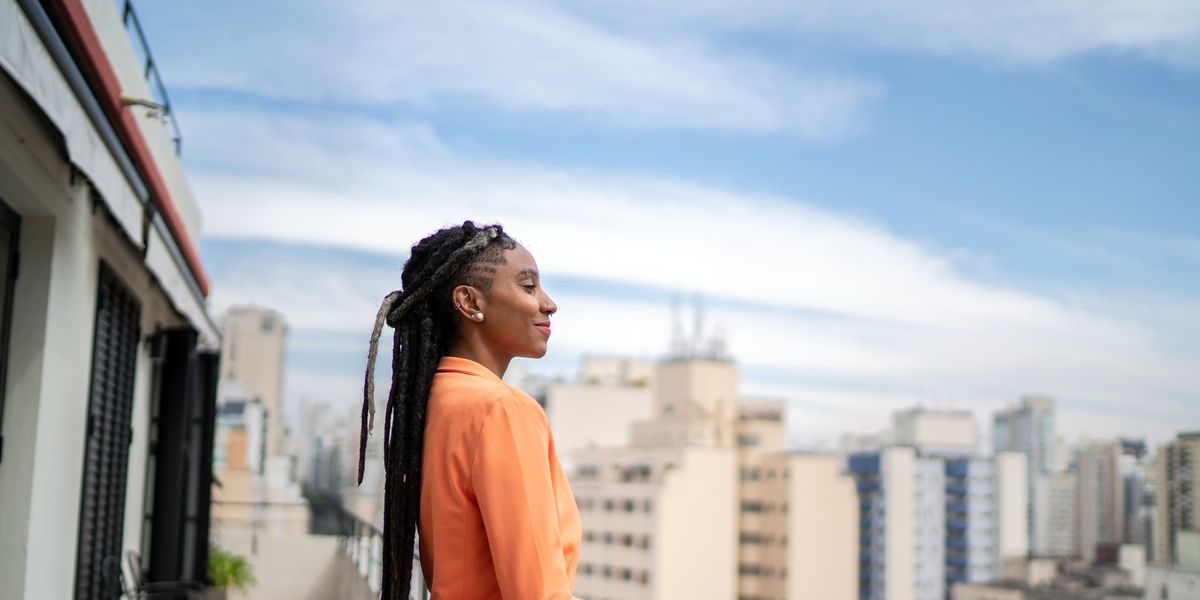 Black-woman-contemplating-on-her-balcony-how-to-be-who-you-want-to-become