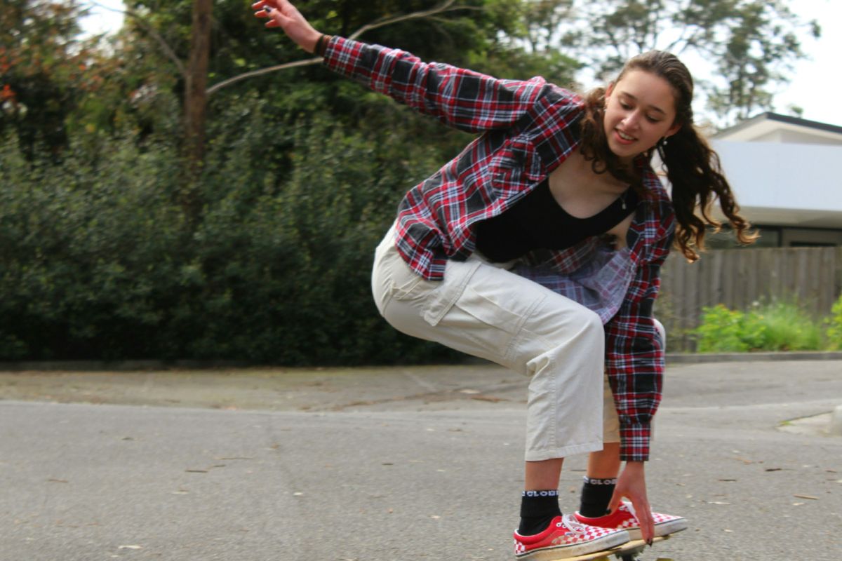 a young girl riding a skateboard