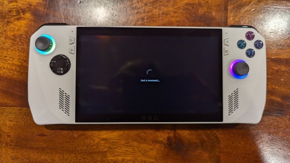 a photo of Asus ROG ALLY (RC71L) handheld gaming PC installing the Microsoft OS on the screen.