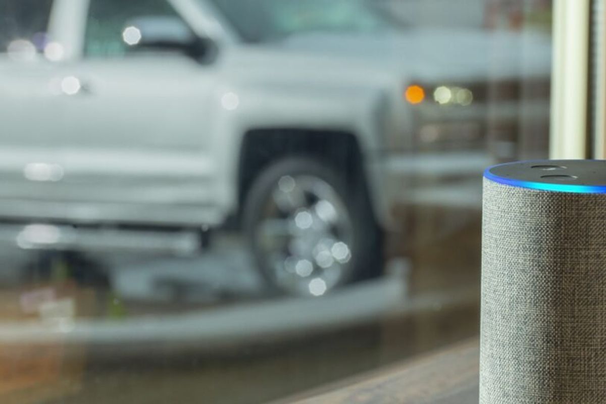 a photo of a Echo and a Chevy truck revealing Cheverolet trucks and cars have Alexa.