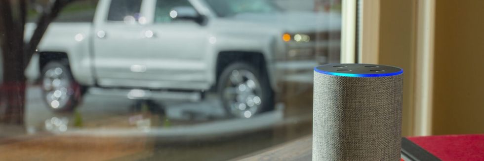 a photo of a Echo and a Chevy truck revealing Cheverolet trucks and cars have Alexa.
