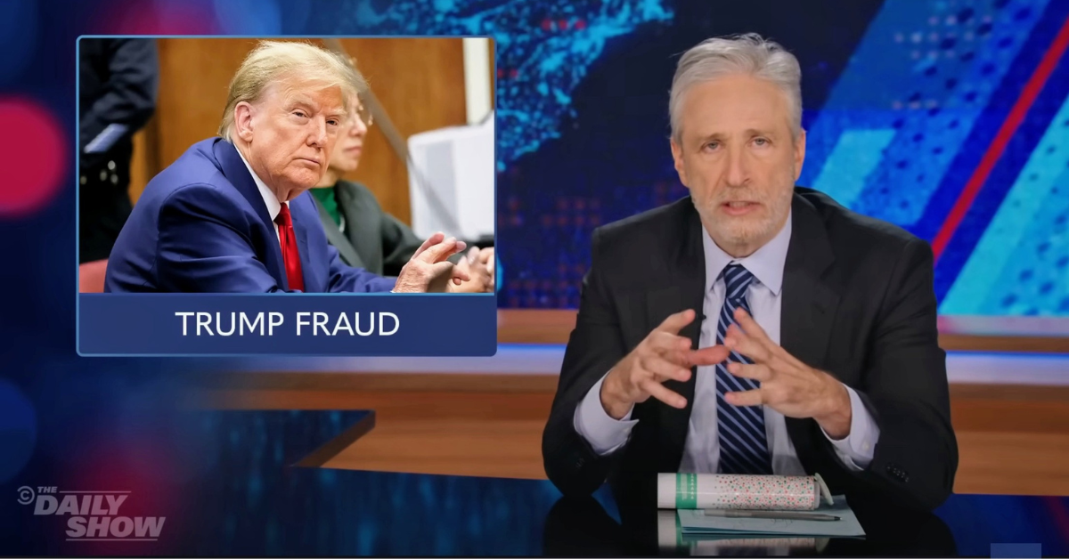 Jon Stewart with a photo of Donald Trump inset