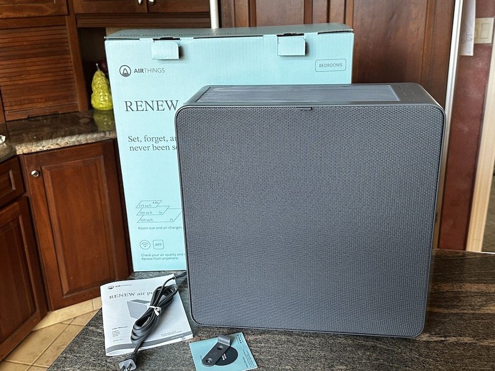 a photo of Airthings Renew Air Purifier unboxed on a countertop.