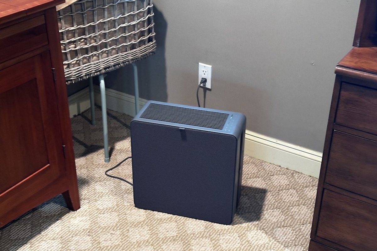 a photo of Airthings Renew Air Purifier in a room plugged in and cleaning the air.