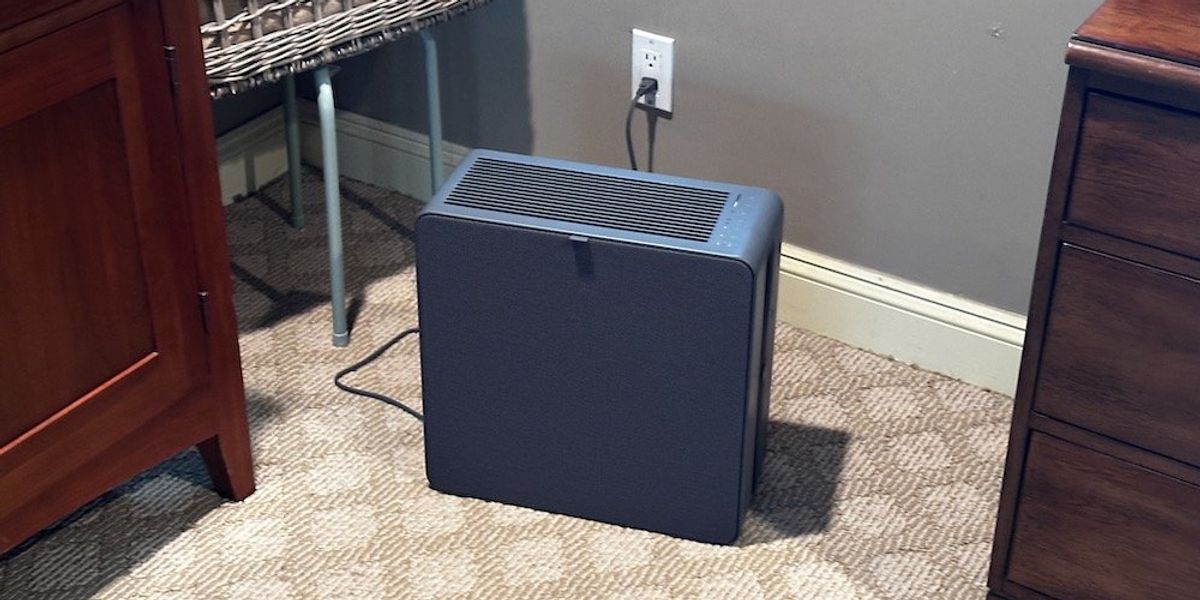 a photo of Airthings Renew Air Purifier in a room plugged in and cleaning the air.
