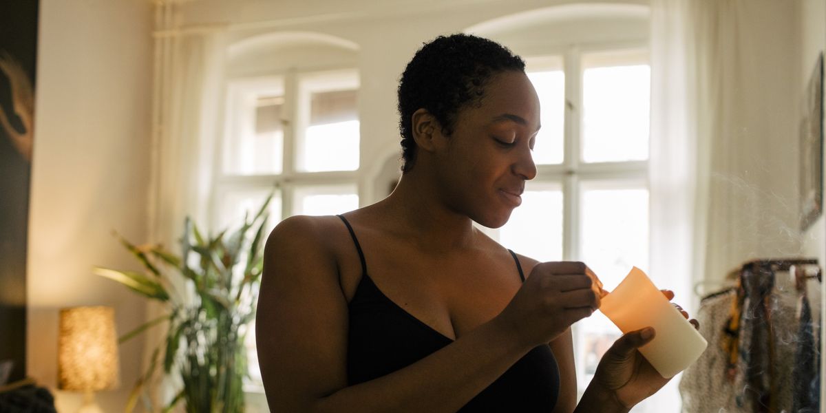Black-woman-lighting-a-candle-in-her-apartment