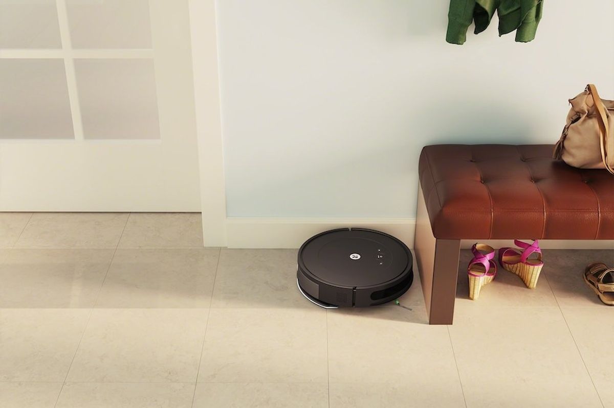 a photo of Roomba Combo Essential vacuum in a entryway