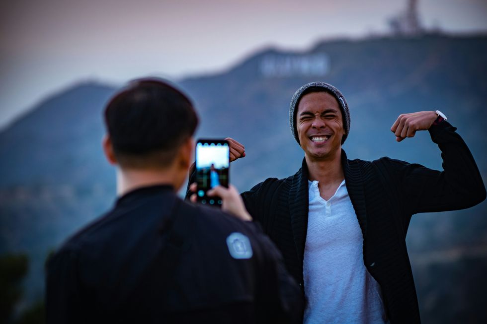 man smiling for a camera with his arms in flex pose