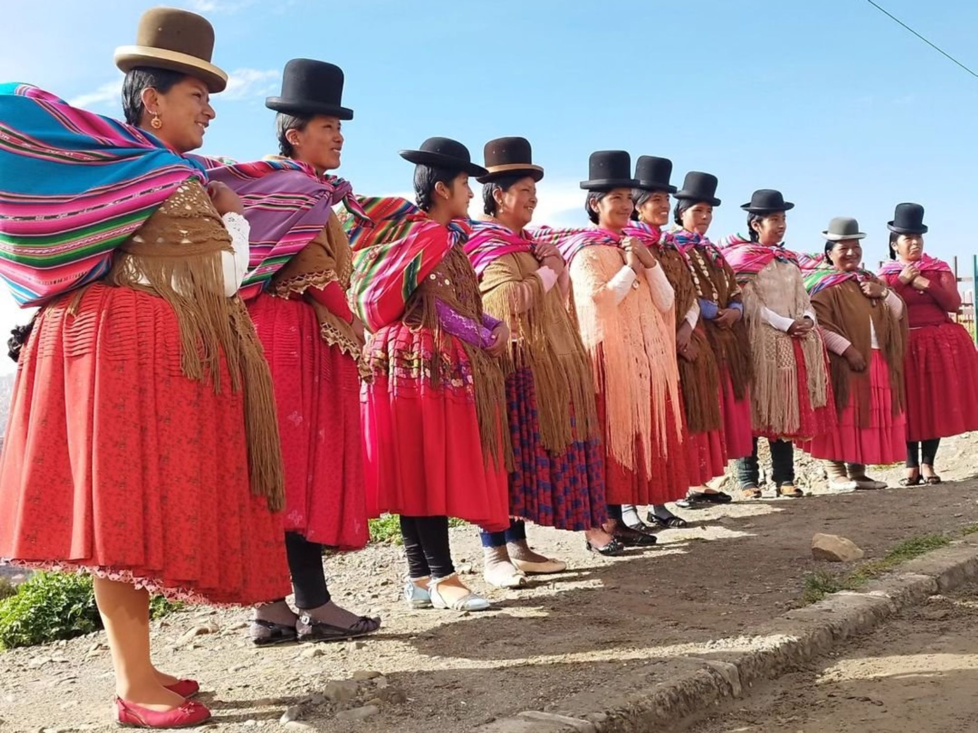 A group of Bolivian cholitas in their traditional costumes, reflecting their rich cultural heritage and identity.