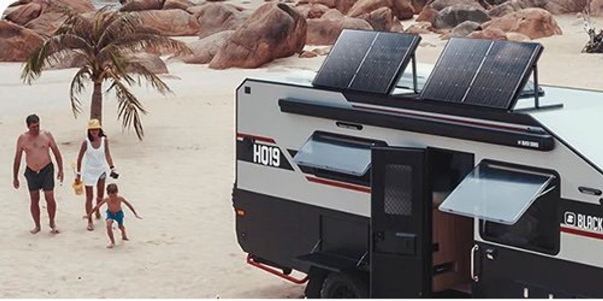 A photo of BougeRV Solar Panels on a RV at the beach