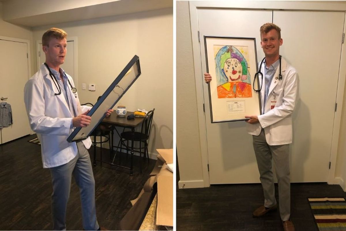 doctor holding up a drawing he did as a child