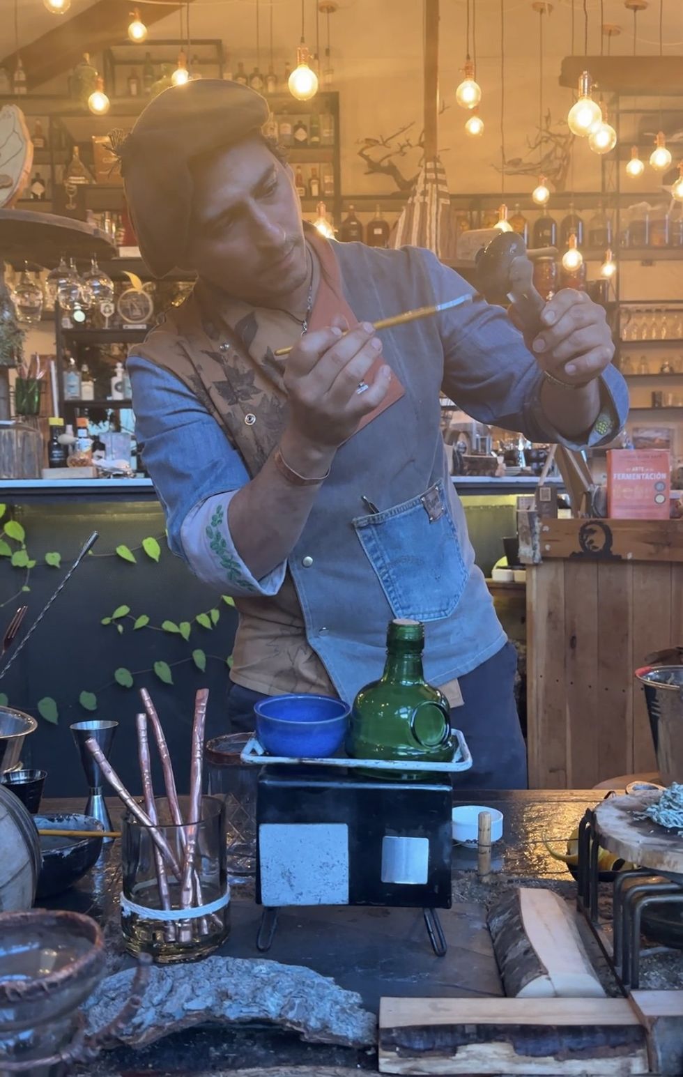 bartender painting a rock held in tongs