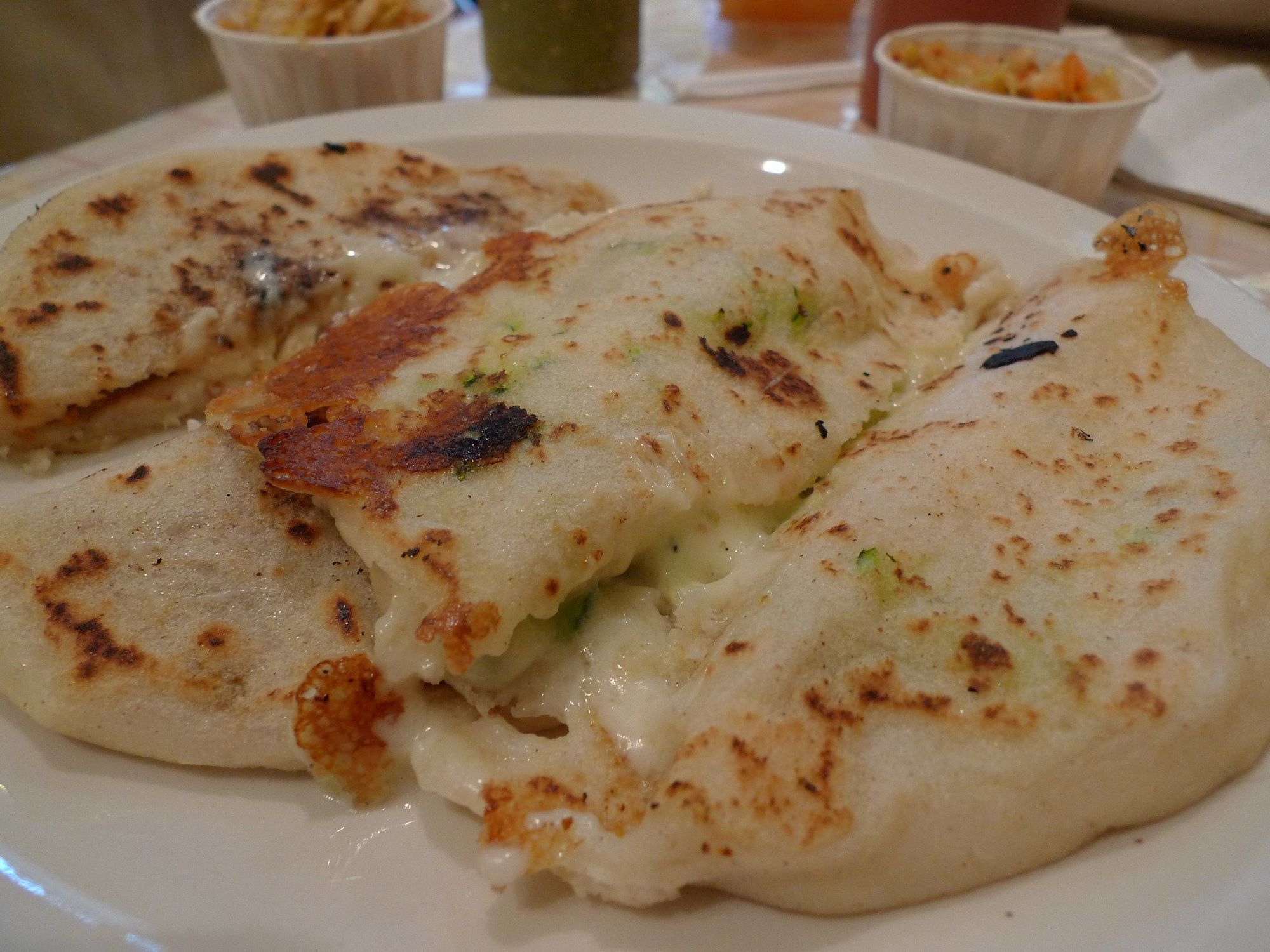 Pupusas filled with pork and cheese and squash and cheese.