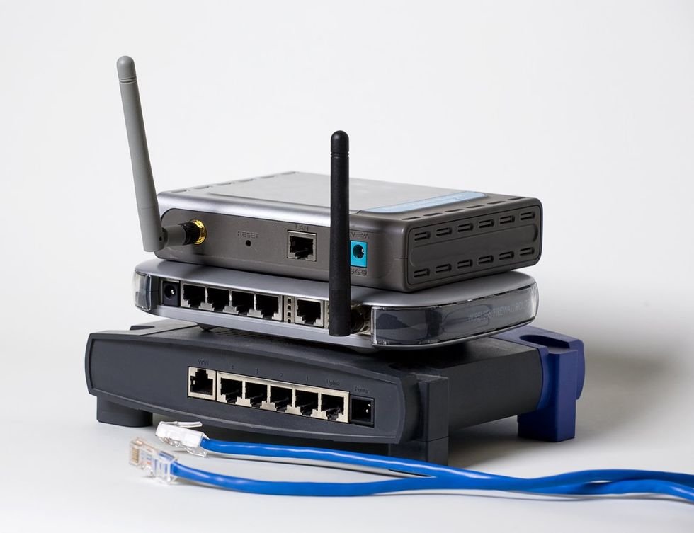 a photo of old routers stacked