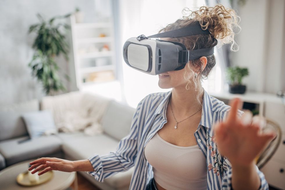 oung woman wearing VR headset stock photo