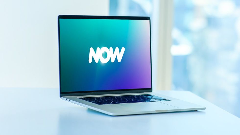 a laptop with Comcast NOW logo on the screen