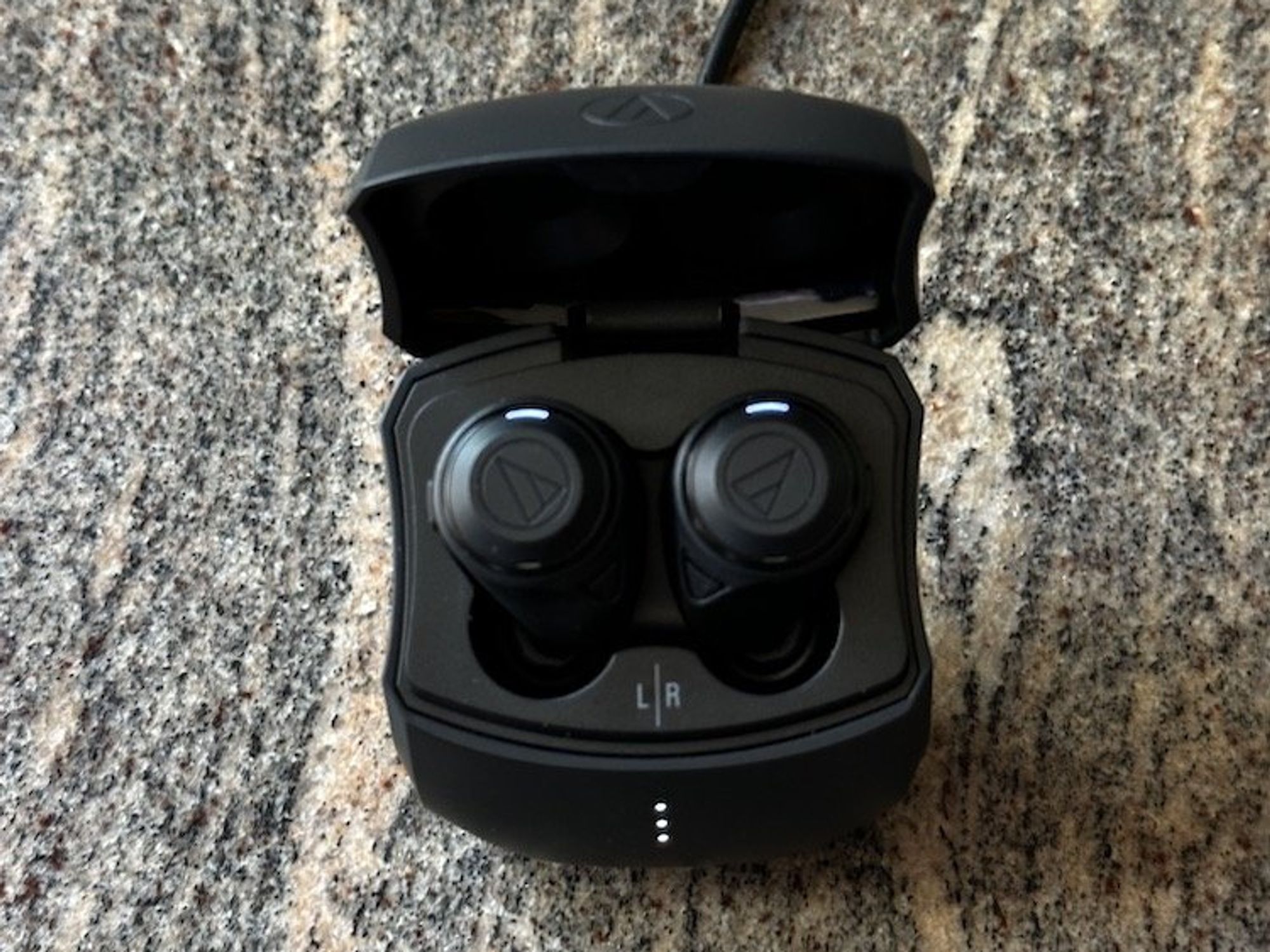 a photo ofo Audio-Technica ATH-CKS50TW Wireless Earbuds charging in case