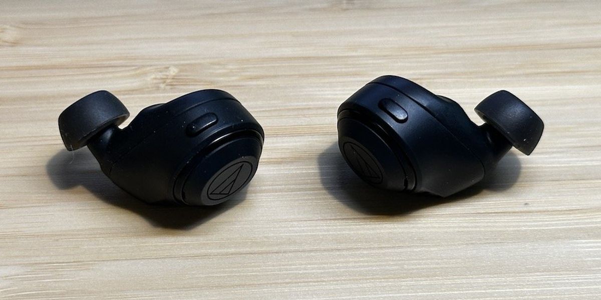 a photo of a pair of Audio-Technica ATH-CKS50TW Wireless Earbuds on a desk.