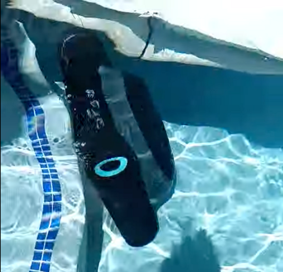 a photo of the Aiper Scuba S1 Cordless Robotic Pool Cleaner cleaning the side of the steps in the pool.