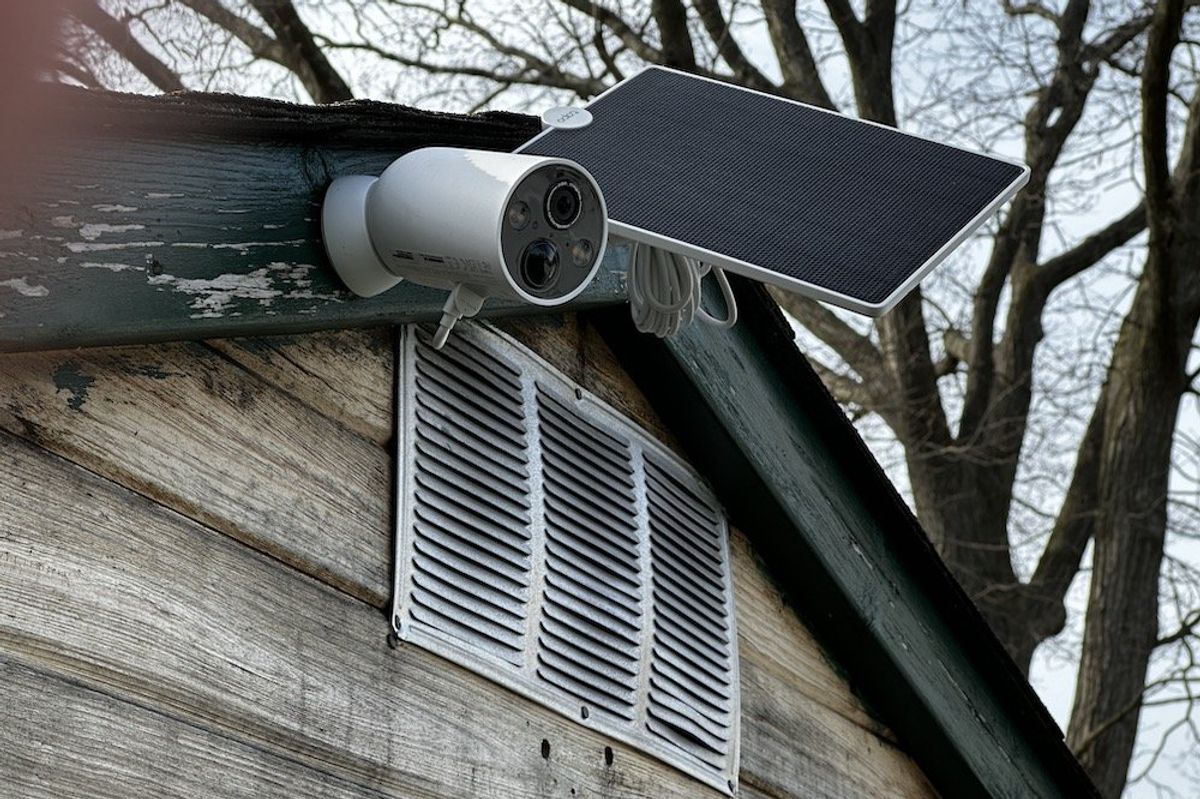 a photo of TP-Link Tapo TC85 Wire-Free Security Camera and Tapo Solar panel on a shed