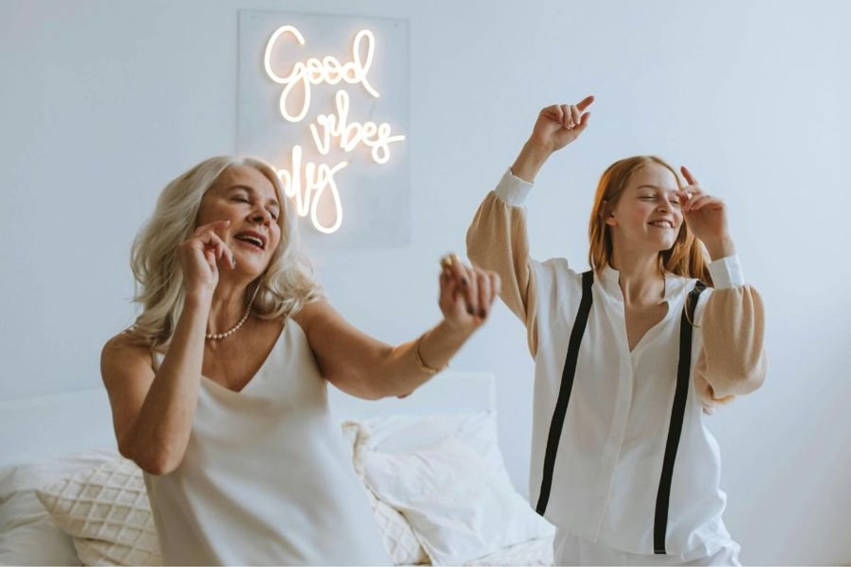teen and older woman dancing together