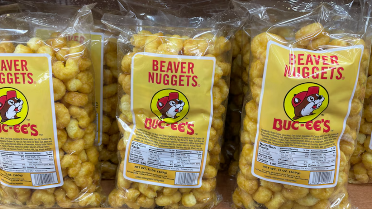 Several large bags of Buc-ee's Beaver Nuggets on a shelf.